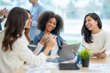 Group of Asian business people meeting to discuss and plan investment business and market analysis for business development There are data project plans for various analyzes and use a laptop computer.