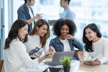 Group of Asian business people meeting to discuss and plan investment business and market analysis for business development There are data project plans for various analyzes and use a laptop computer.