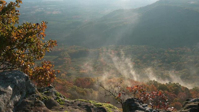 Mist and fog rising from the fall colored Ozark forest trees of Arkansas from Nebo Mountain 