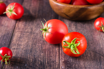 Ripe organic tomatoes on a wooden table. Harvest and local products.