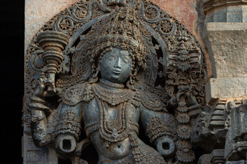 Fototapeta na wymiar The Sculpture of Doorkeeper of Hoysaleshwara Temple, Beautiful Intricates of Ornaments, Hoysala Temple, Halebeedu, Hassan, Karnataka, India.