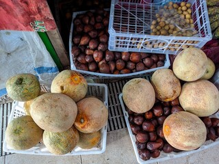a photo of various fruits placed in baskets for sale in the market