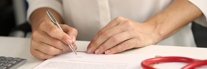 Person signs pen health insurance contract closeup