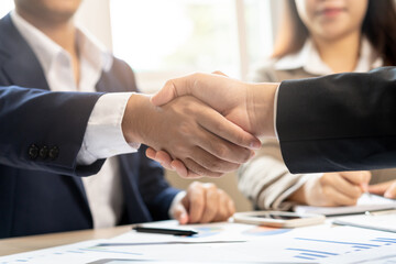 Congrats, business partnership people, asian happy young businessman handshake, shaking hands with partnership, customer or colleague after finishing successful meeting, good deal. People working.