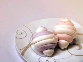 Multicolored marshmallows on a white plate