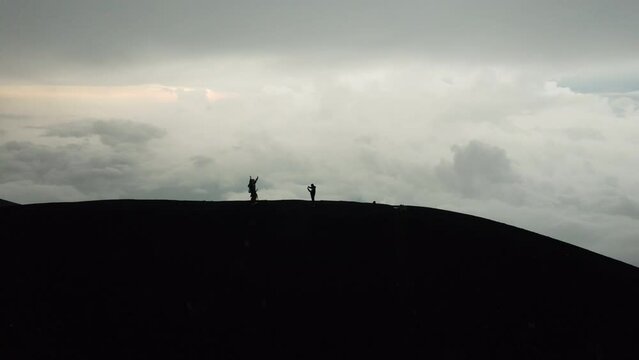 Travellers taking pictures at foot of Volcan de Fuego, abstract silhouettes
