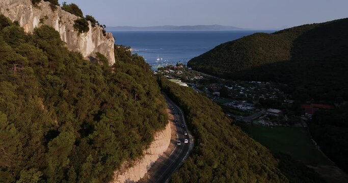 Aerial view over a mountain road, revealing the Rabac town, in Istria, Croatia