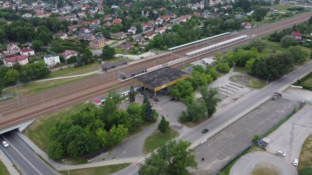 Flyover of abandoned train station, train tracks, motorcycle speedway, sports arena, and chemical factory in Moscice industrial district in Tarnow (Tarnów) Poland - 4K 30FPS Drone Tracking In