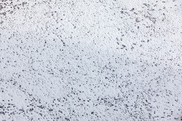 Snowy surface with footprints . White background covered by snow