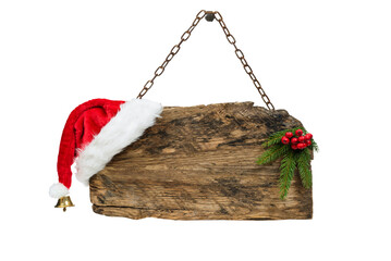 Christmas template - old wooden sign with Santa hat and spruce twig hanging on a rusty chain isolated on a transparent background.