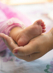 baby feet in a hand
