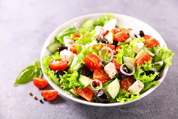 fresh mixed salad with tomato,  lettuce,  olive and feta cheese