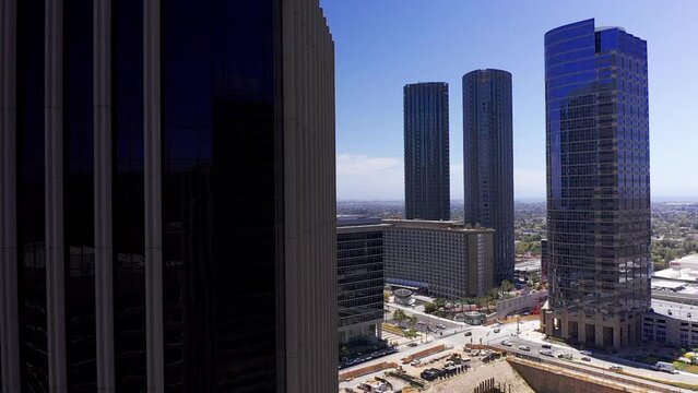 Aerial close-up dolly shot revealing Century City from behind a skyscraper. HD at 60 FPS