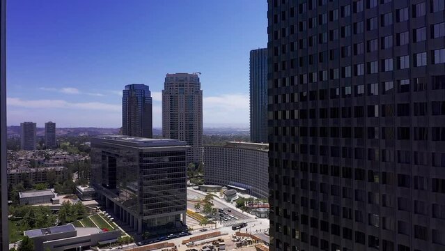 Aerial dolly shot around skyscraper to reveal Century City, California. HD at 60 FPS