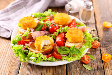 mixed vegetable salad with toast and goat cheese