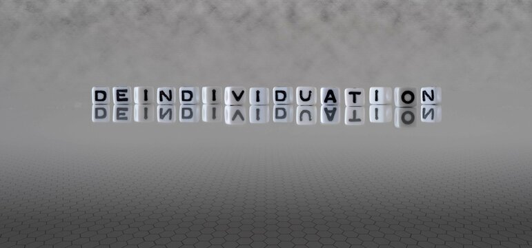deindividuation word or concept represented by black and white letter cubes on a grey horizon background stretching to infinity