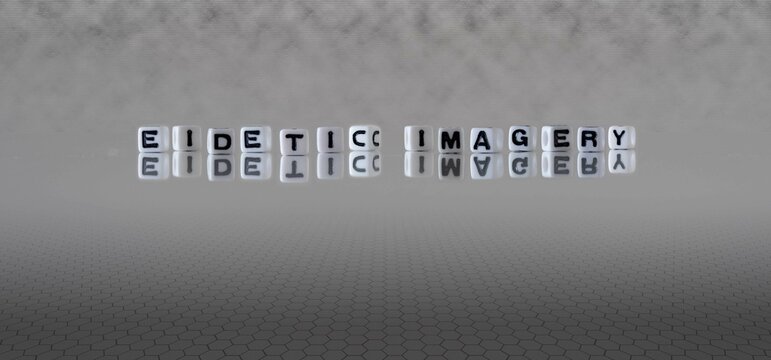 eidetic imagery word or concept represented by black and white letter cubes on a grey horizon background stretching to infinity