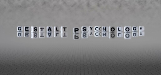 gestalt psychology word or concept represented by black and white letter cubes on a grey horizon background stretching to infinity - obrazy, fototapety, plakaty