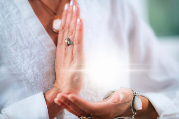 Sense of purpose meditation. Hands of a emotionally aware person during meditation, helping people...