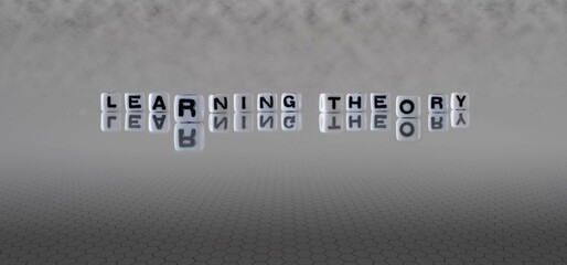 learning theory word or concept represented by black and white letter cubes on a grey horizon...