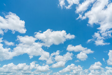 Naklejka na ściany i meble Beautiful blue sky and white cumulus clouds abstract background. Cloudscape background. Blue sky and fluffy white clouds on sunny day. Nice weather. Beauty cumulus cloudscape. Summer sky weather.