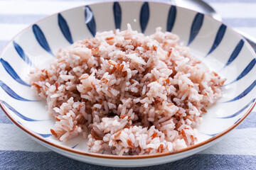 Riceberry rice in a white dish is a wholesome and high-vitamin rice.