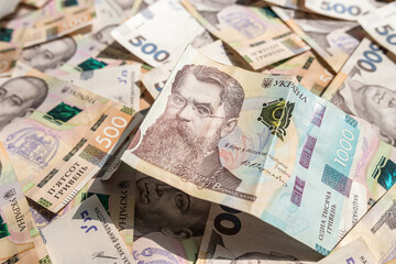 Obraz na płótnie Canvas banking and finance banknotes of 500 1000 Ukrainian hryvnia as background