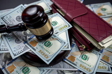 Judicial wooden gavel of a man in a robe on the background of dollars money isolated.