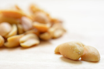 Salted Peanuts on natural light background. Front view close up.