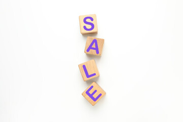 Wooden cubes with text Sale on white background