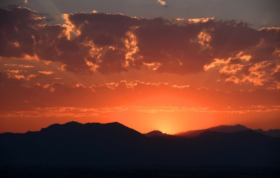 fiery sunset over the front range of the colorado mountains due to the smoke from  the western forest fires, as seen from broomfield, colorado