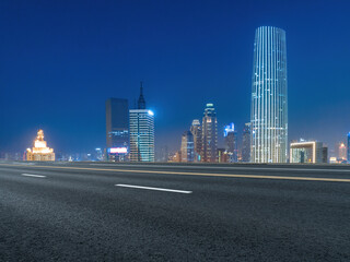 Fototapeta na wymiar Empty road and city buildings background