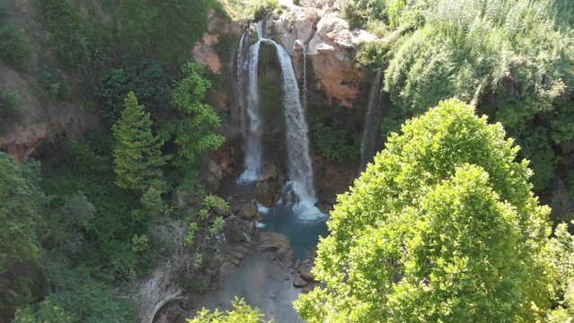 Aerial view of waterfall in Gorgo de la Escalera, Valencia, Spain. Tilt down.