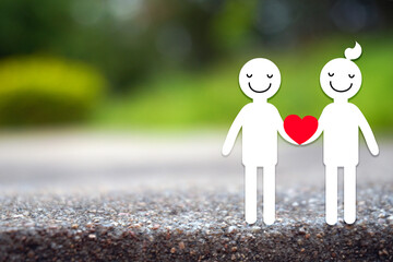 Stickfigure couples holding red heart