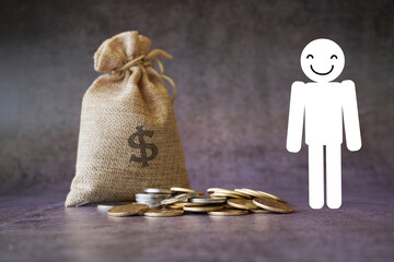 Happy man standing with money bag and coins