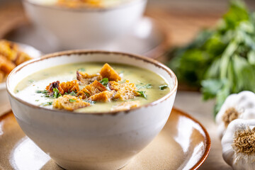 Garlic cream soup with bread croutons in bowl - obrazy, fototapety, plakaty