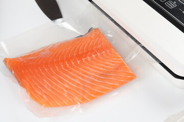 Salmon fillets in a vacuum package. Sous-vide, new technology cuisine. Selective focus, copy space
