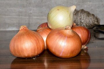 Yellow and white onions on dark wooden background