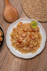 Sausage fried rice with egg and vegetables in white plate