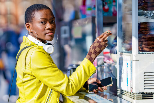 Woman wearing leather jacket standing at concession stand