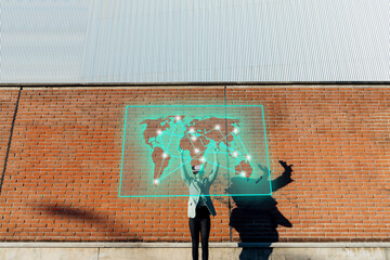 Businesswoman with VR glasses touching projection screen in front of wall