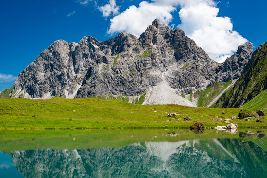 Lake Eissee in front of Allgau Alps on sunny day