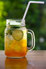 ice tea with slice of lemon in mason jar 