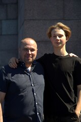 Autumn dad and son hugging outdoors and happy