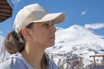 Woman on the observation deck against the backdrop of the Caucasian snow-capped mountains