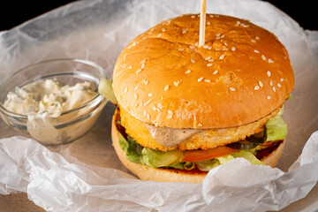 tasty burger on the parchment paper