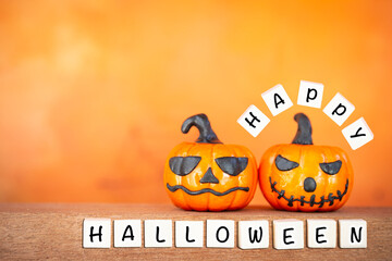 Happy halloween sign  with funny Halloween pumpkin over blurred orange background, invitation card background idea