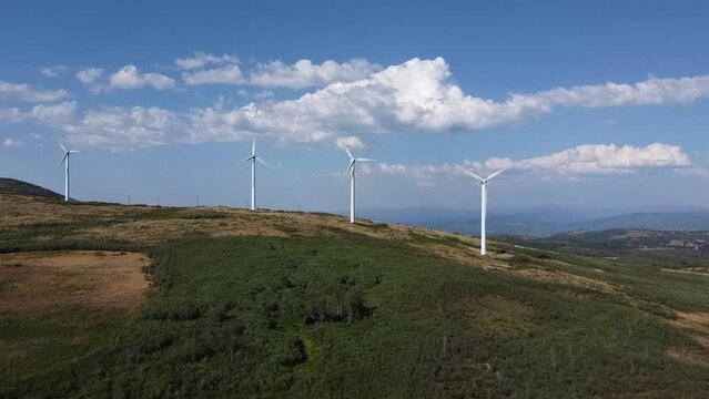 eolic generators spining with the wind in the mountains on a sunny day