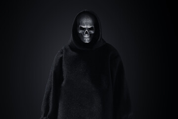 Fototapeta na wymiar Grim reaper on dark background