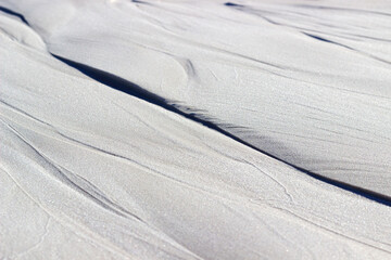 wet white sand, cement with a beautiful pattern close-up is used as a background